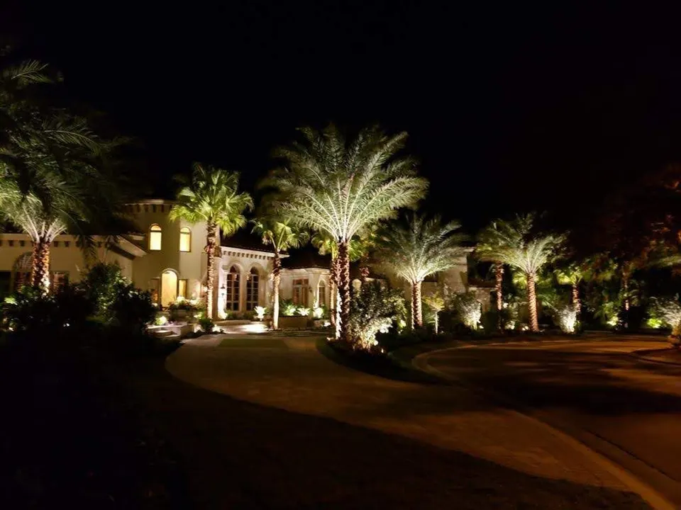 The front of an estate lit at night