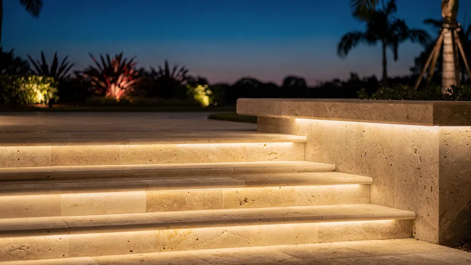 Illustration of stone steps beside a low wall, the treads lit from beneath the wall cap